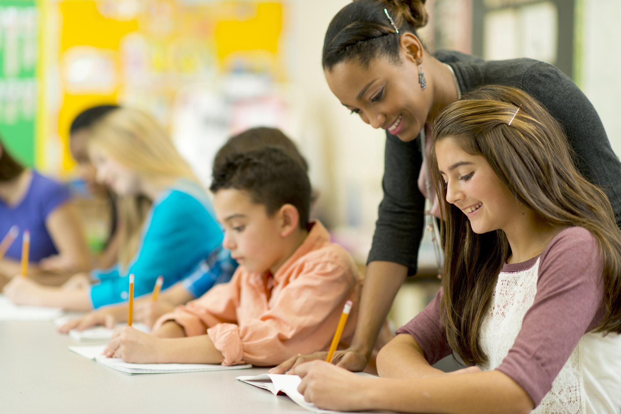 teacher helping middle school students