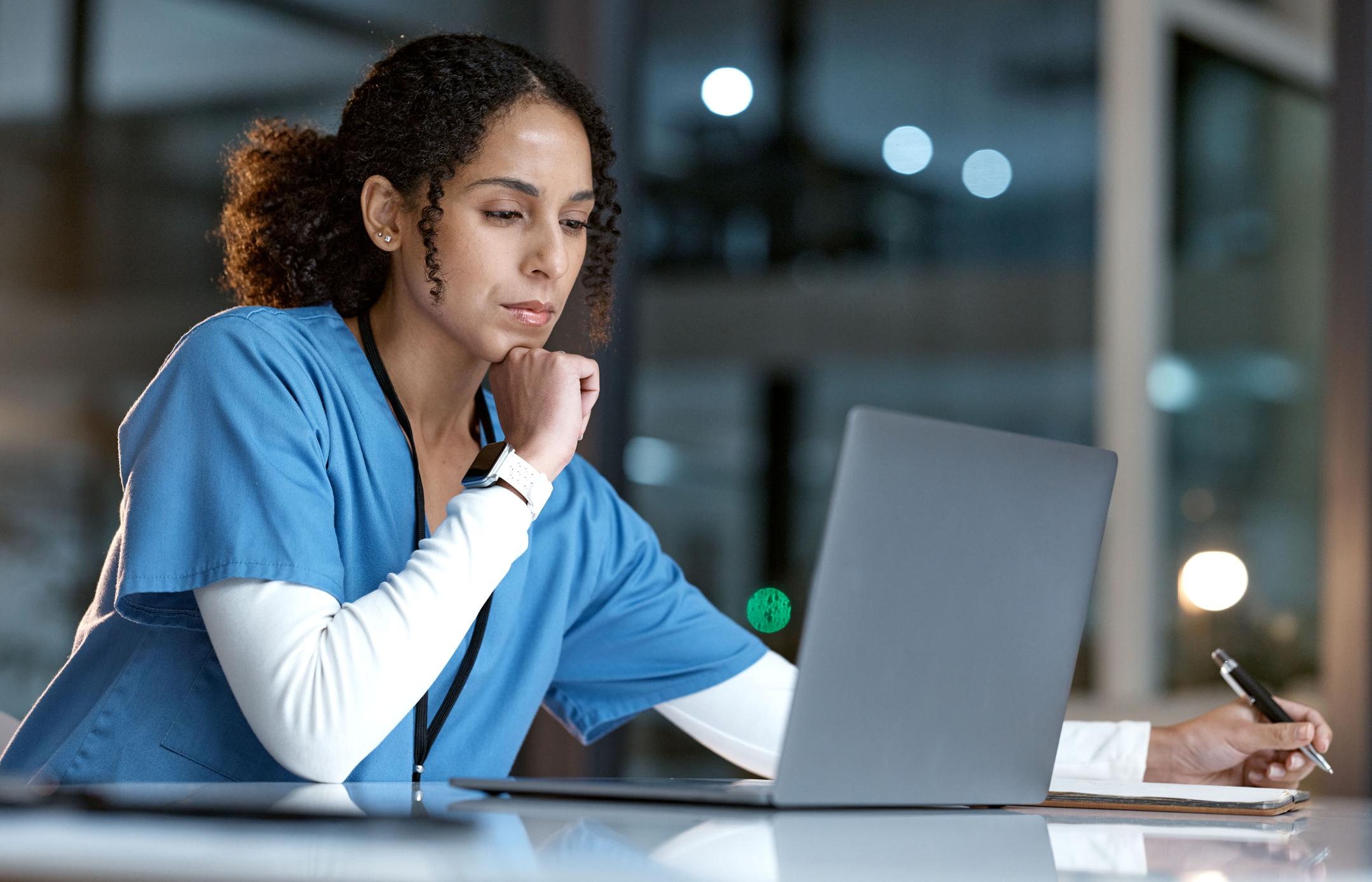 nurse looking at a laptop