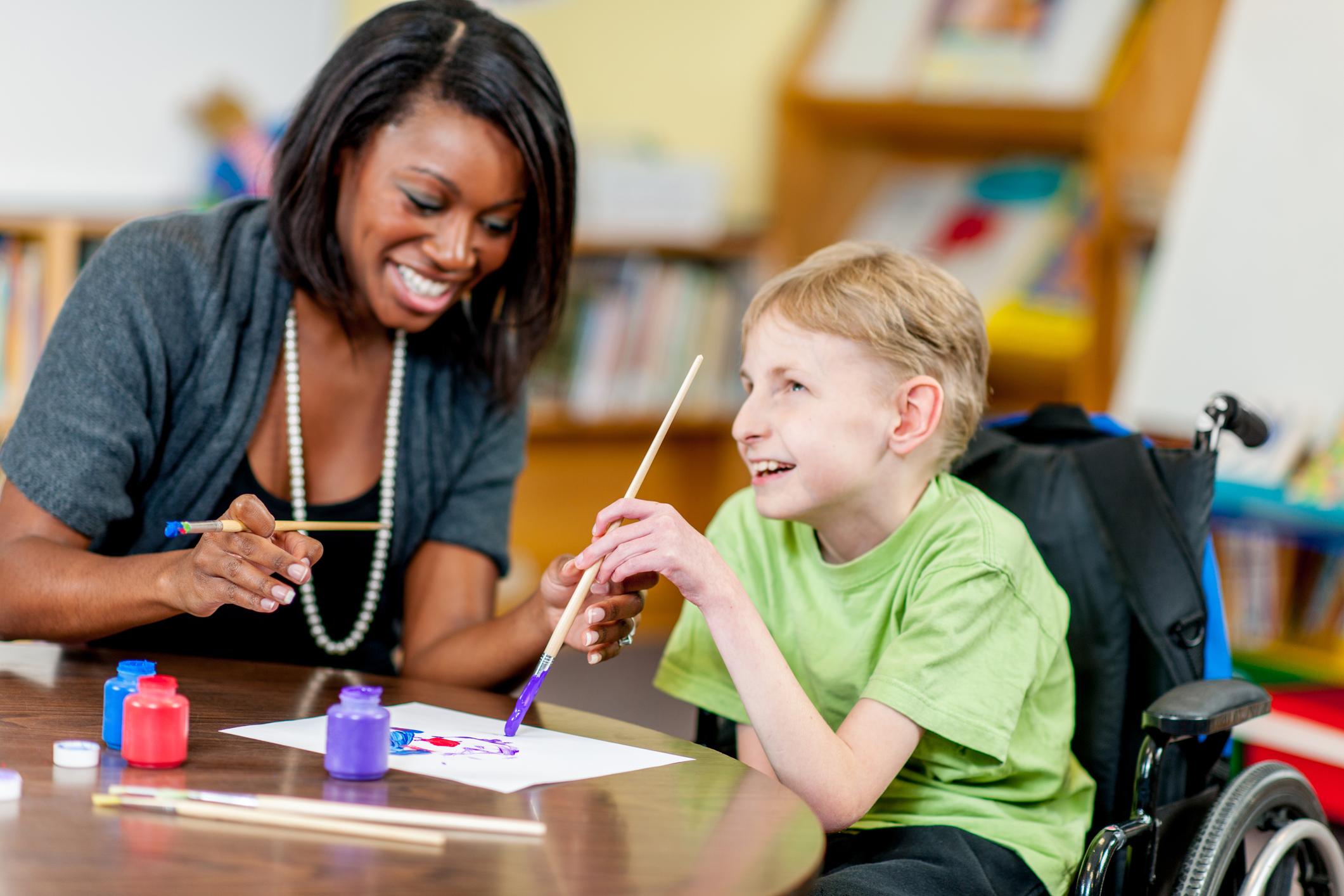 teacher working with student